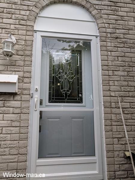 Single entry front door. Steel insulated White. Half glass. Classic stained glass collection. Self storing storm door. Round top flashing capping above the door. Installed